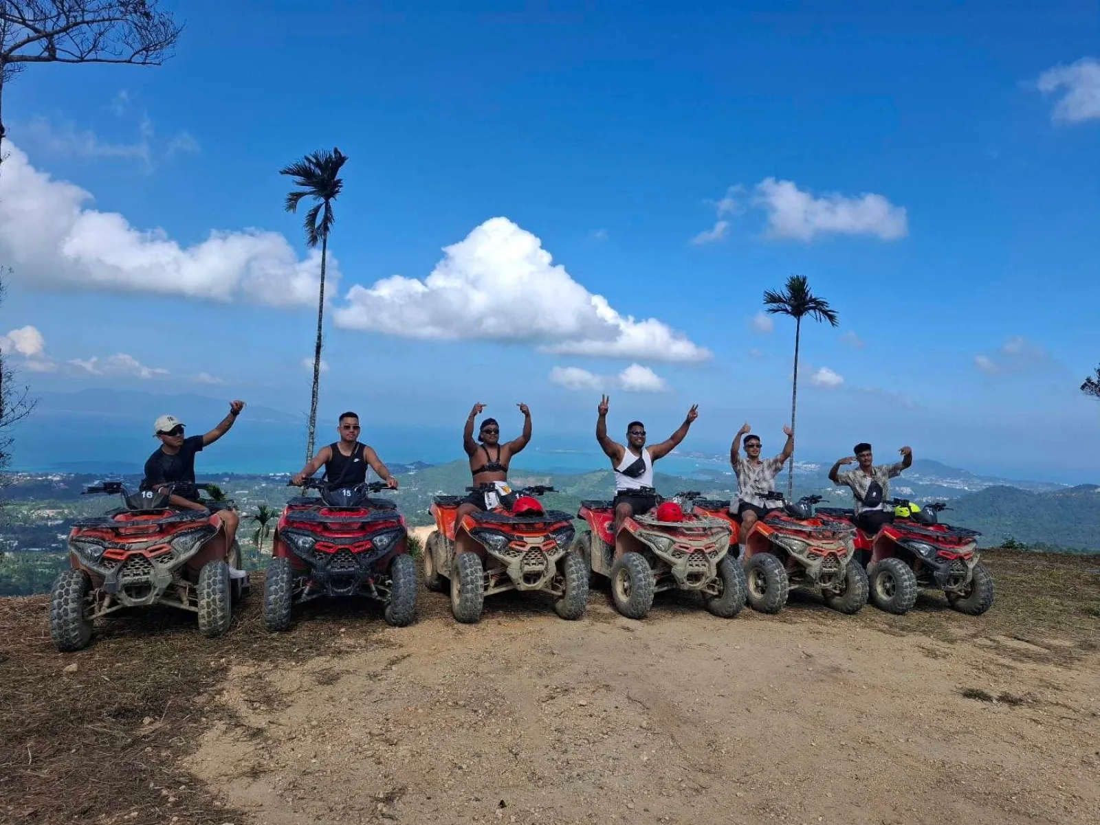 Seven ATV riders lined up at a mountain viewpoint above Koh Samui's north coast