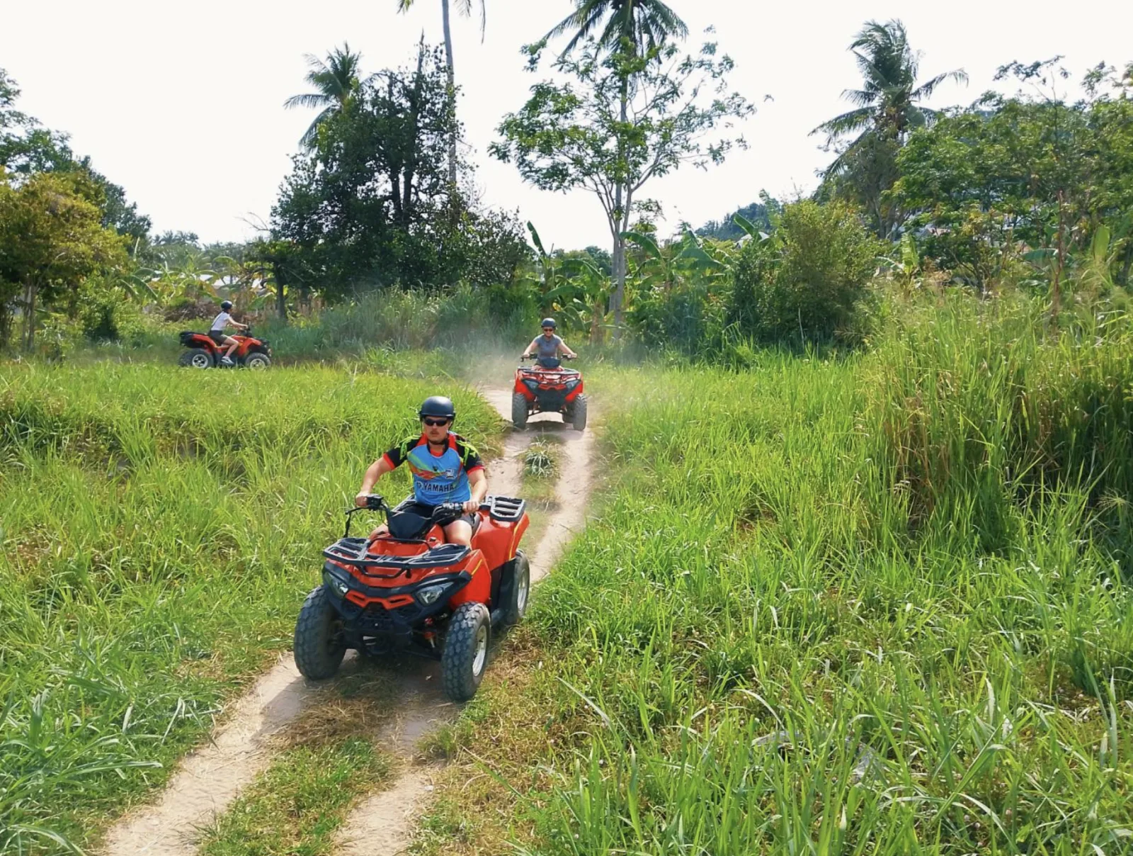 Quad bikes on a dusty backroad climbing into Koh Samui's mountains