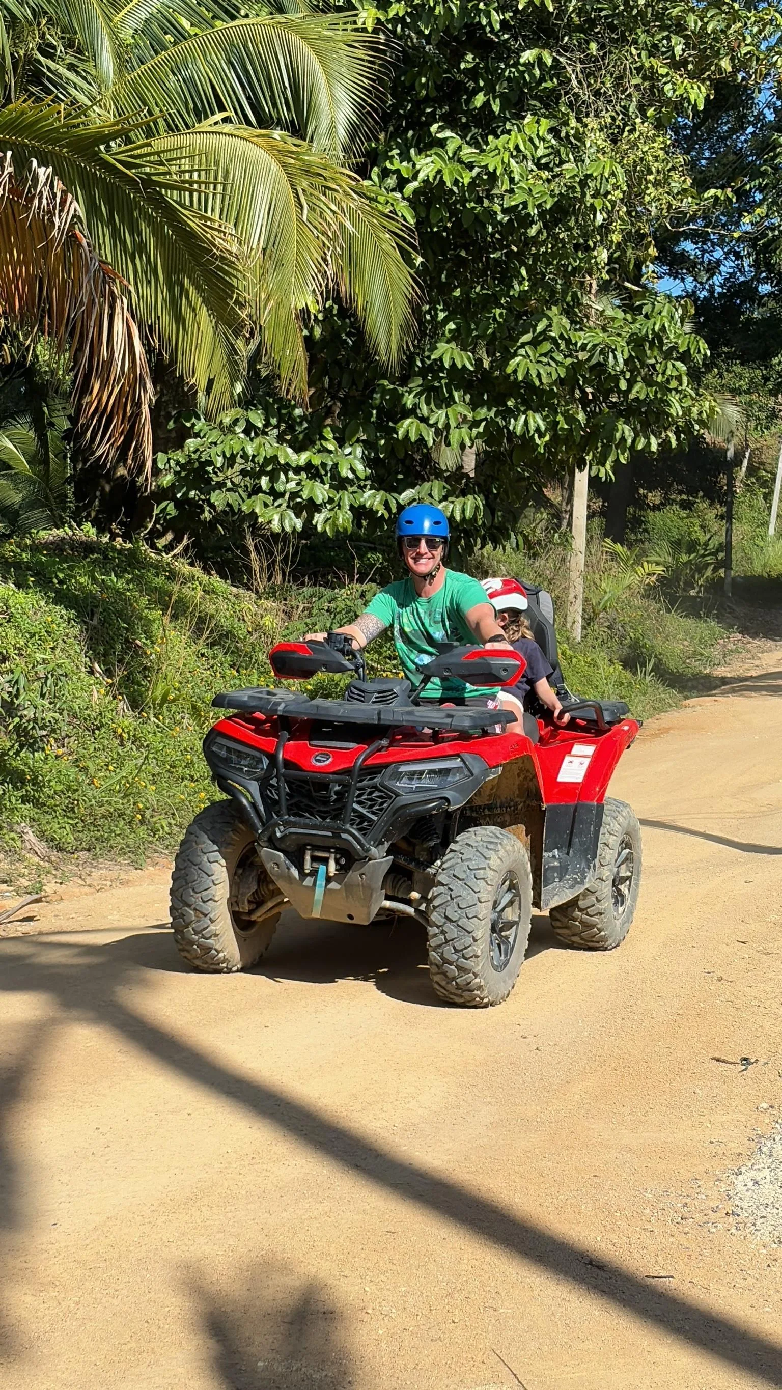 Rider and passenger on a X Quad machine on a dirt road through Koh Samui's jungle