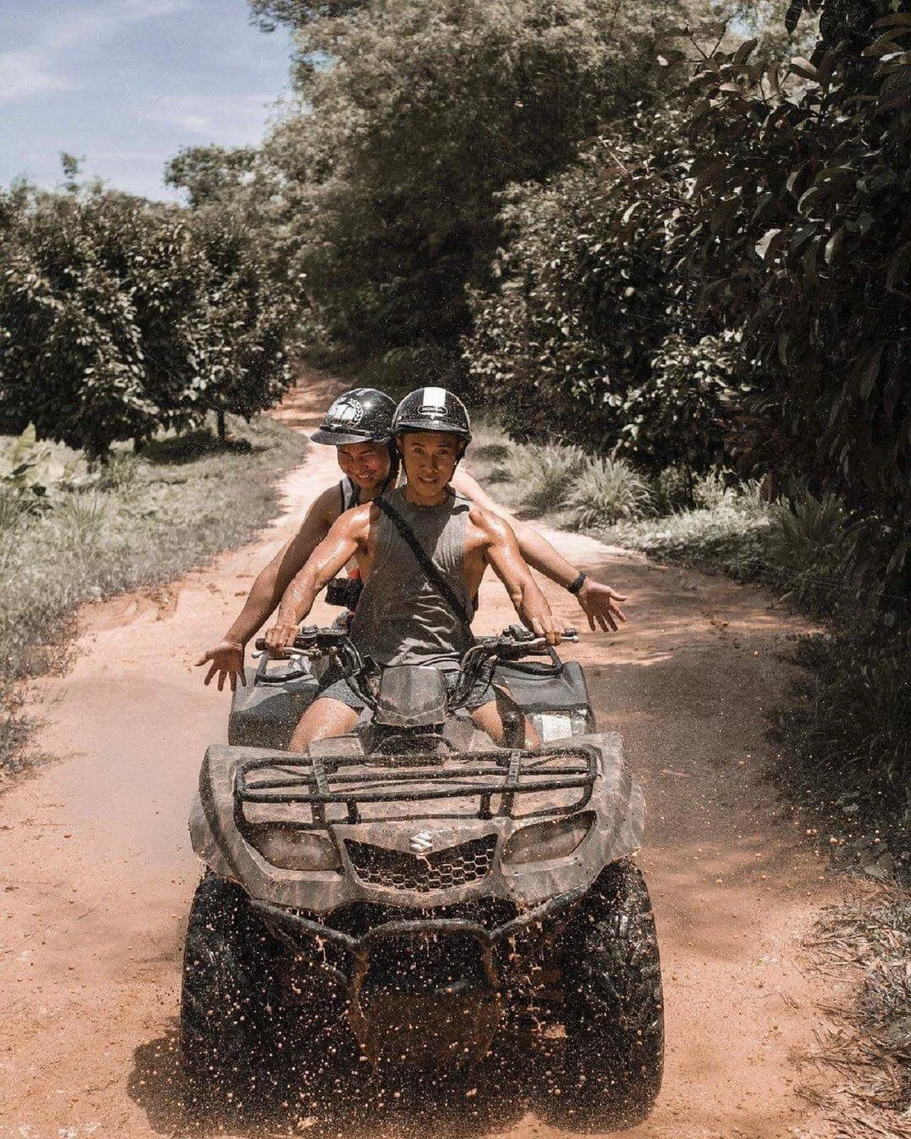 A driver and passenger sharing one X Quad machine on a Koh Samui mountain trail