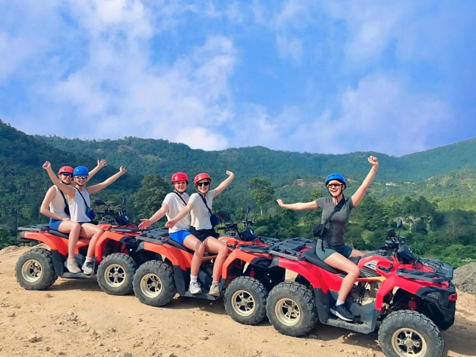 Quad bikes on a muddy jungle trail through coconut plantation on Koh Samui